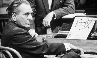 Schwarzweißaufnahme von Komponist Loewe am Klavier mit Notenblatt und konzentriertem Blick